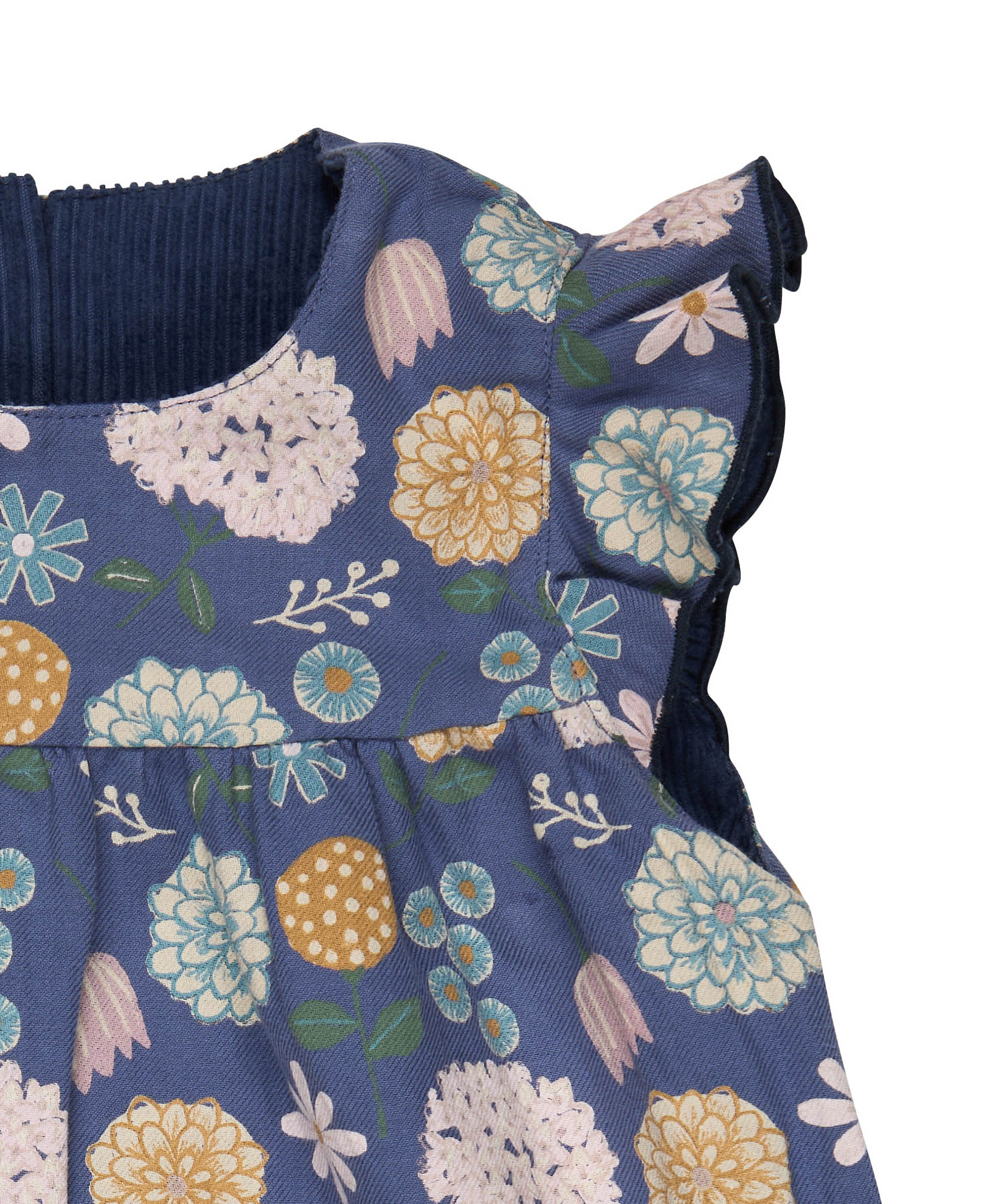 A close up of the navy winter shift print detail on the Pigeon organics winter berry dress showing the frill detail available at Babipur