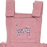 A close up of the pink cat embroidery from the Pigeon Organics corduroy pinafore dress available at Babipur showing the button fastener detail on the shoulder straps 