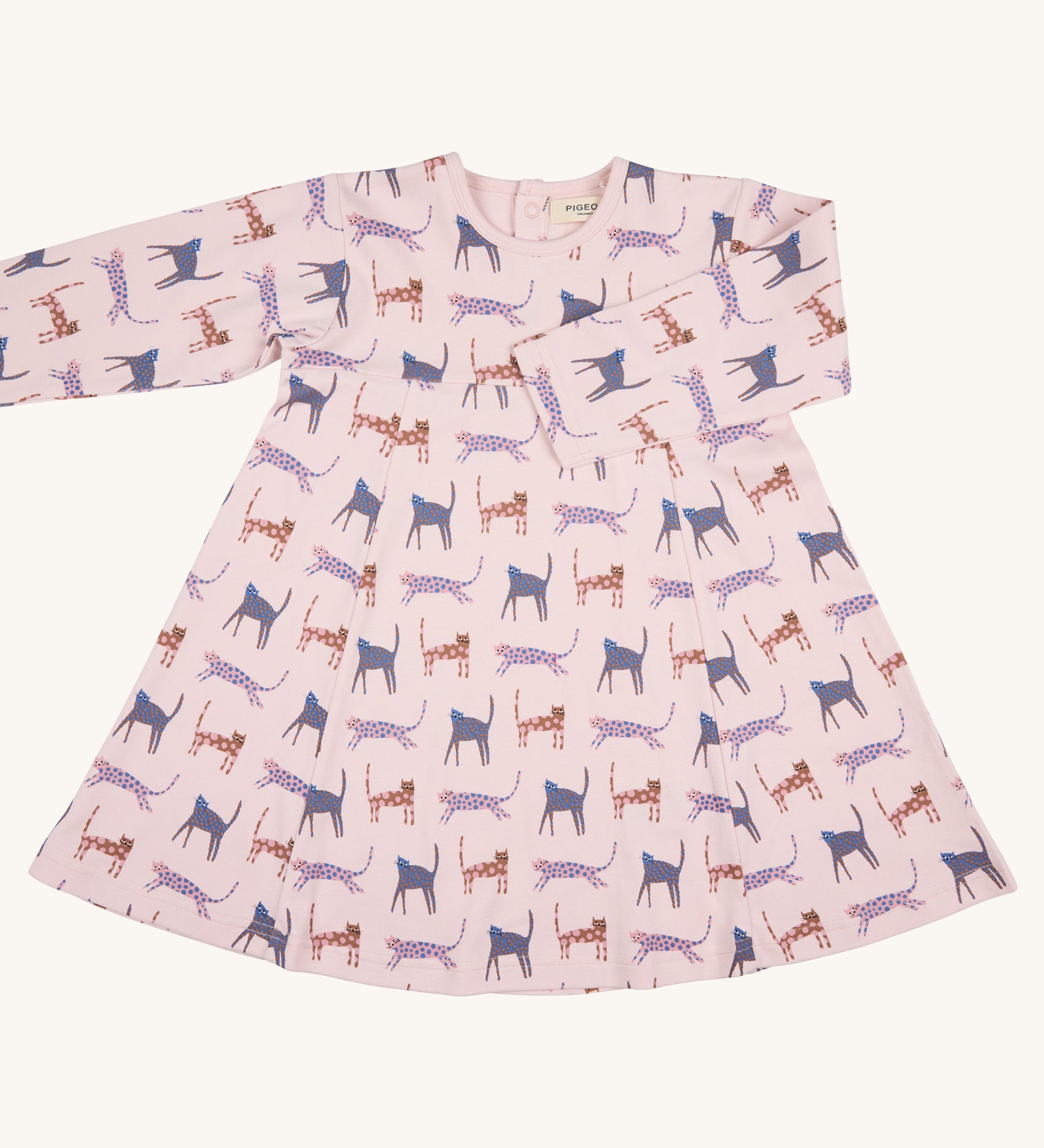 Pigeon Organics pinafore dress - GOTS organic cotton pink long sleeved dress with a popper fastener on the back for easy fitting. Features multiple prints of playful cats in pinks and purples