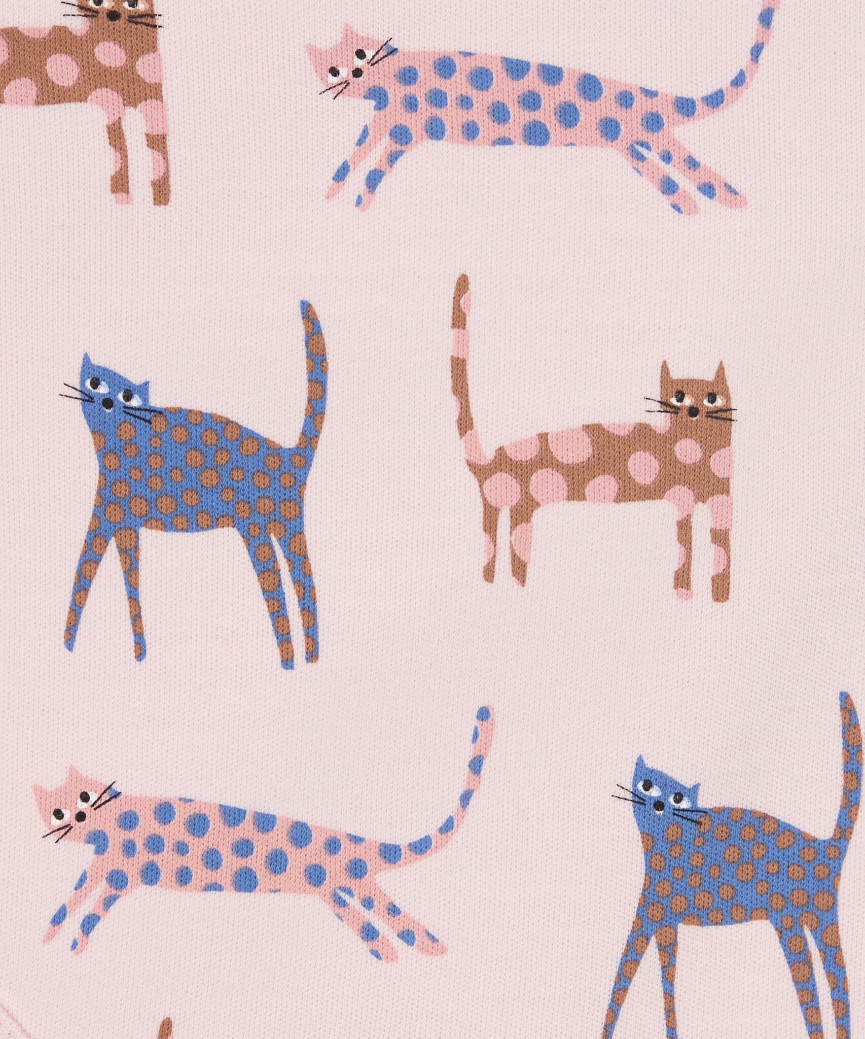 Close up of the Pigeon Organics pink cats design. Showing the different coloured playful cats with spots on light pink organic cotton fabric