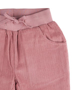 A close up of the Pigeon Organics lined cord trousers available at Babipur showing the pink elasticated detail and matching drawstring.