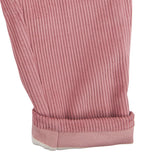 A close up of the Pigeon Organics lined cord trousers available at Babipur showing the pink and white striped design on the inner liner 