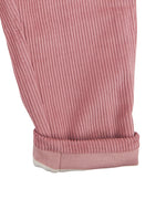 A close up of the Pigeon Organics lined cord trousers available at Babipur showing the pink and white striped design on the inner liner 