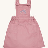 Pigeon Organics pinafore- GOTS organic cotton pinafore sleeves dress in pink corduroy. Features 2 small pockets at the front, button fasteners on the shoulders, an elasticated waist band and a pink cat embroidery on the chest.