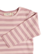 A close up of the pink breton striped Pigeon organics long sleeve top available at Babipur showing the popper fastener detail on the shoulder
