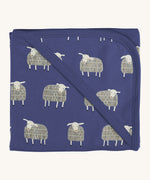 Pigeon Organics hooded blanket. A 100% GOTS organic cotton navy hooded blanket with white sheep printed all over. 