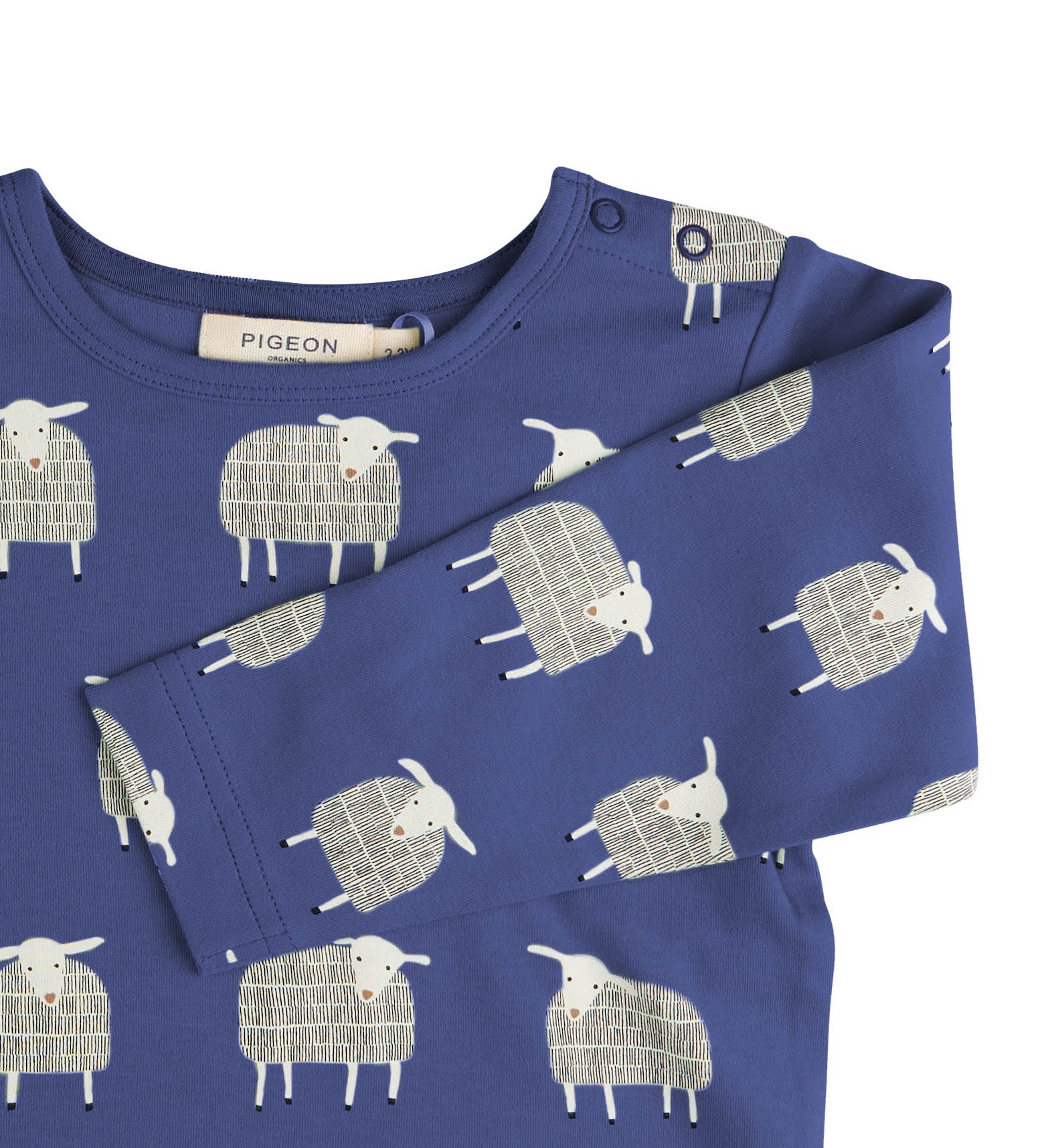 A close up of the navy sheep  Pigeon organics long sleeve top available at Babipur showing the popper fastener detail on the shoulder