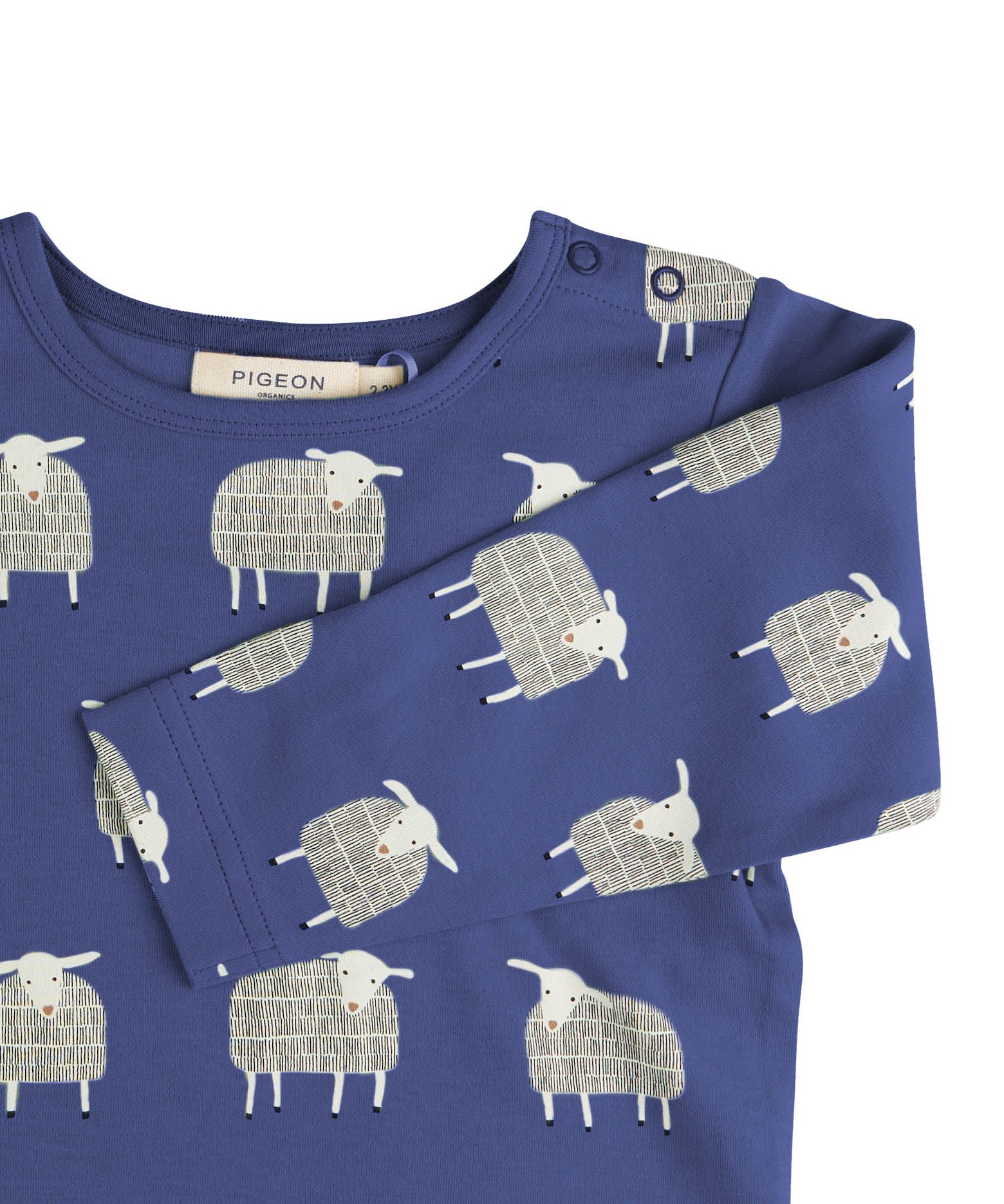 A close up of the navy sheep  Pigeon organics long sleeve top available at Babipur showing the popper fastener detail on the shoulder