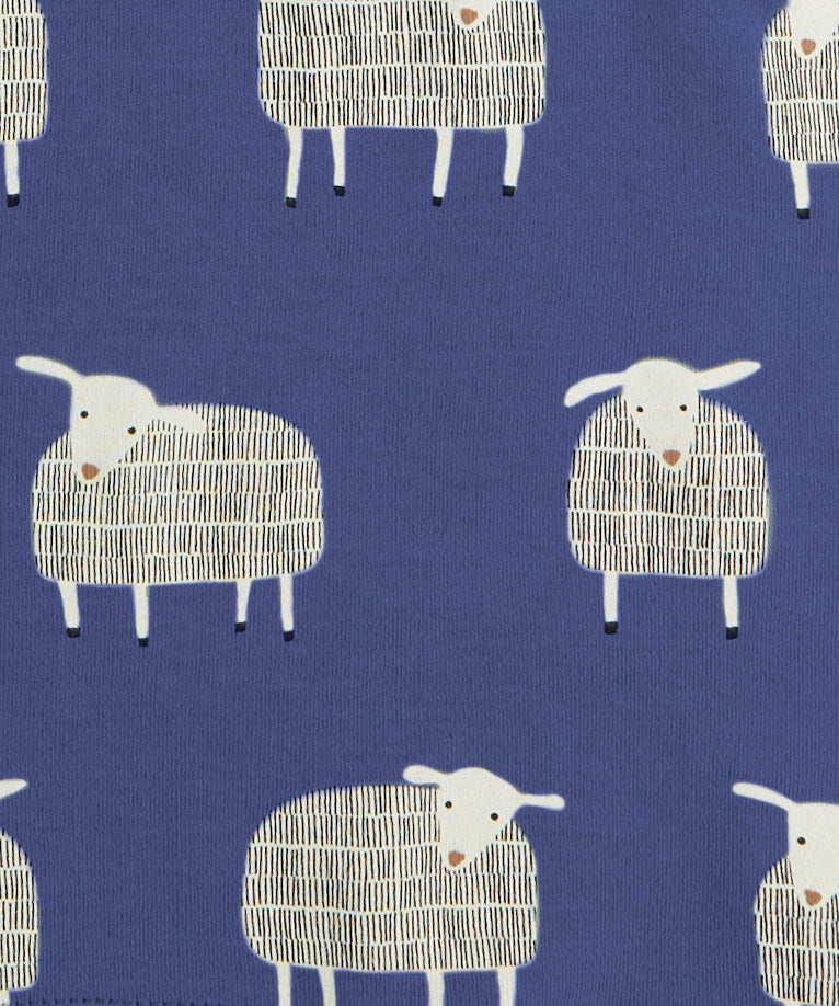 A close up of the navy sheep print on from Pigeon organics available at Babipur showing 