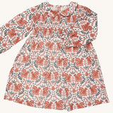 Pigeon Organics smock dress with Peter Pan collar - GOTS organic cotton long sleeves dress in neutral colour with a gentle elasticated wrist cuff for a snug fit. Features multiple prints of squirrels and leaves. 