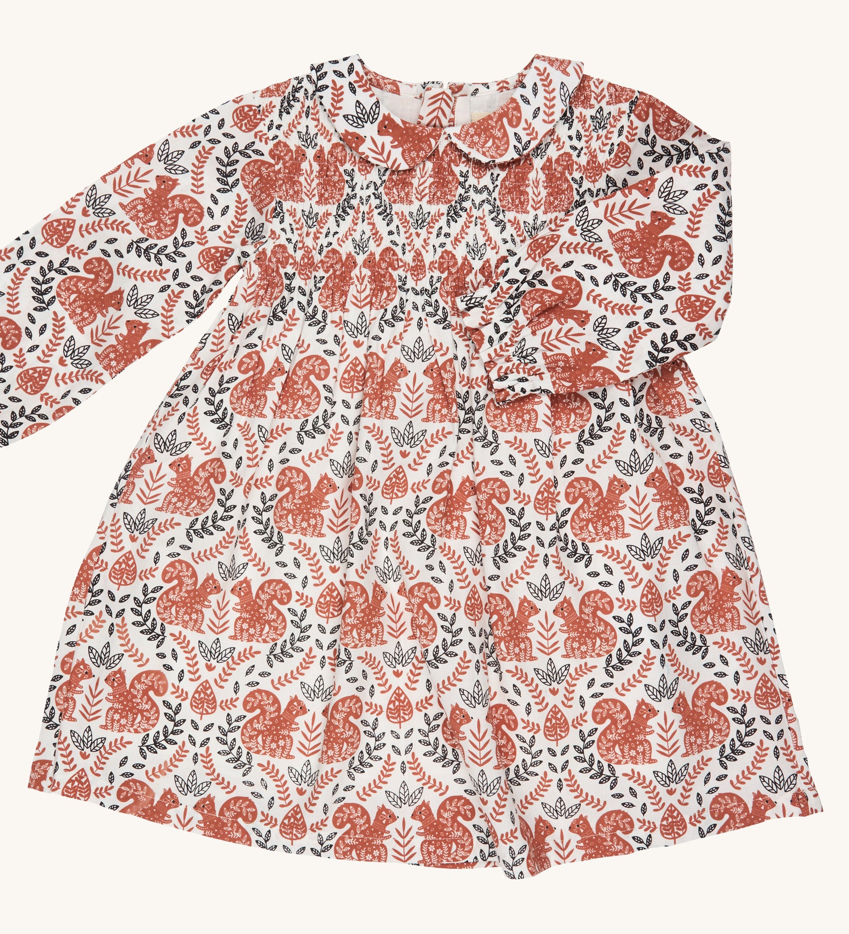 Pigeon Organics smock dress with Peter Pan collar - GOTS organic cotton long sleeves dress in neutral colour with a gentle elasticated wrist cuff for a snug fit. Features multiple prints of squirrels and leaves. 