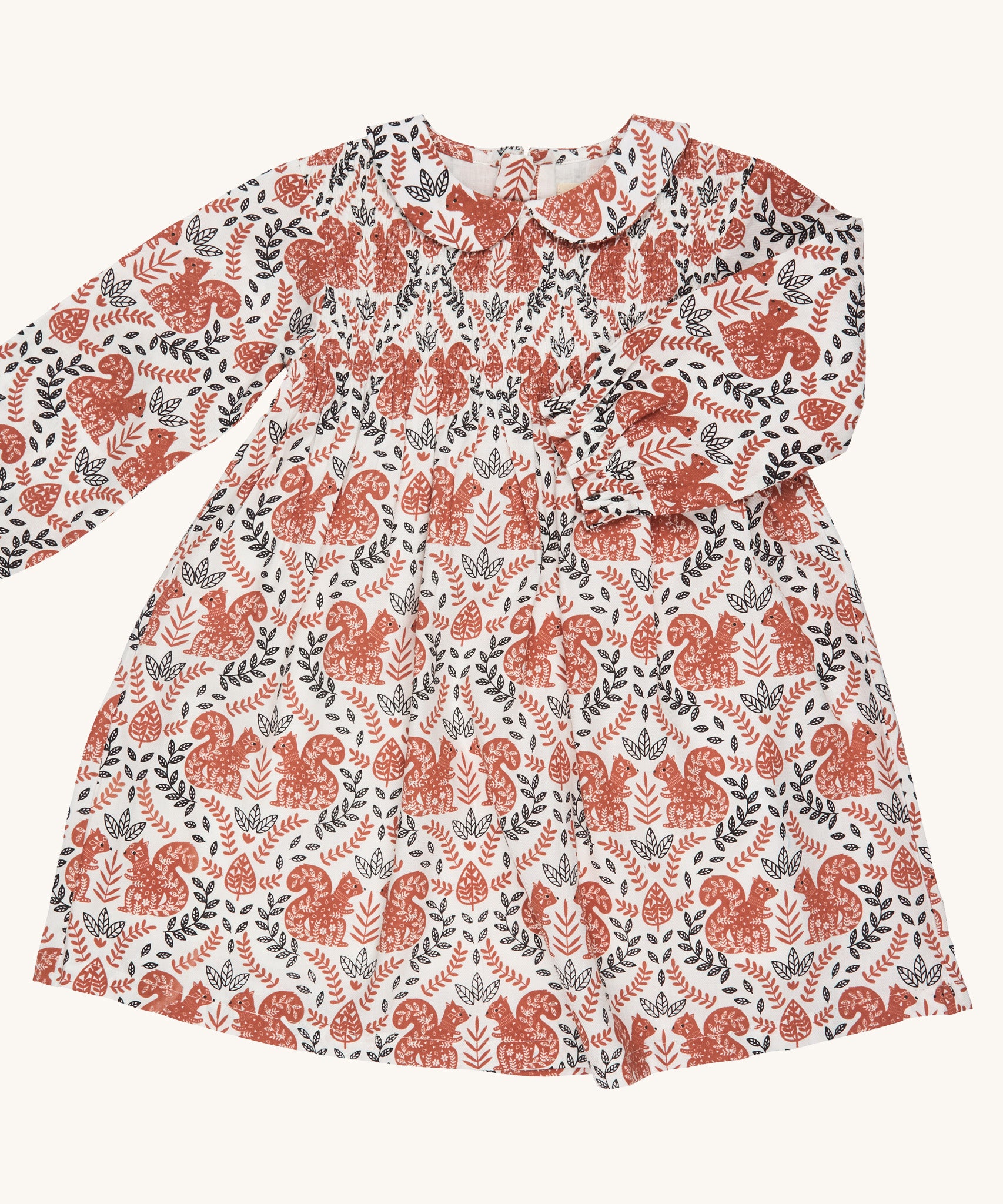 Pigeon Organics smock dress with Peter Pan collar - GOTS organic cotton long sleeves dress in neutral colour with a gentle elasticated wrist cuff for a snug fit. Features multiple prints of squirrels and leaves. 