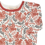 A close up of the orange squirrel  Pigeon organics long sleeve top available at Babipur showing the popper fastener detail on the shoulder