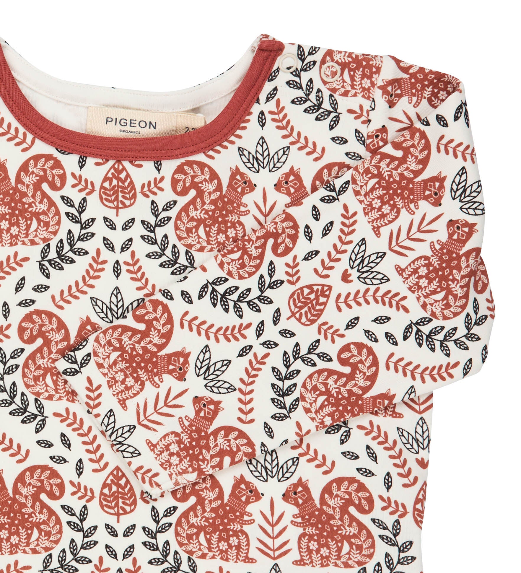 A close up of the orange squirrel  Pigeon organics long sleeve top available at Babipur showing the popper fastener detail on the shoulder