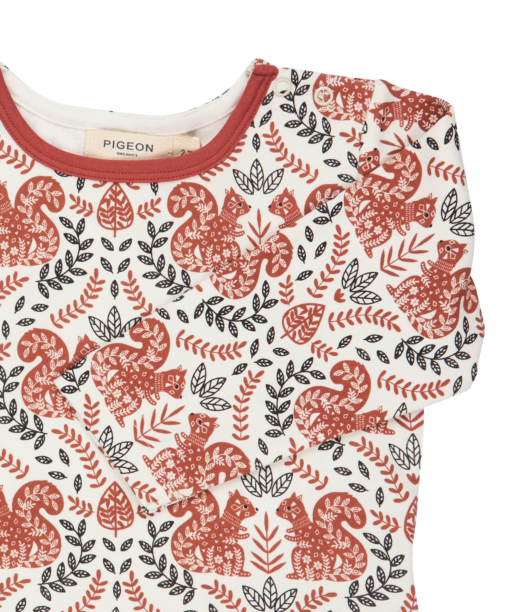 A close up of the orange squirrel  Pigeon organics long sleeve top available at Babipur showing the popper fastener detail on the shoulder