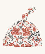 Pigeon Organics knotted baby hat - 100% GOTS organic neutral coloured cotton hat with a top knot. Features multiple artistic prints of a light brown squirrels and leaves