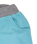 A close up of the Pigeon Organics lined cord trousers available at Babipur showing the grey elasticated waistband detail and side pocket