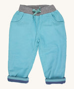 Pigeon Organics lined cord trousers - GOTS turquoise coloured organic cotton trousers in a corduroy style. Features 2 side pockets, a soft elastic waistband in grey and turquoise drawstring detail at the front.