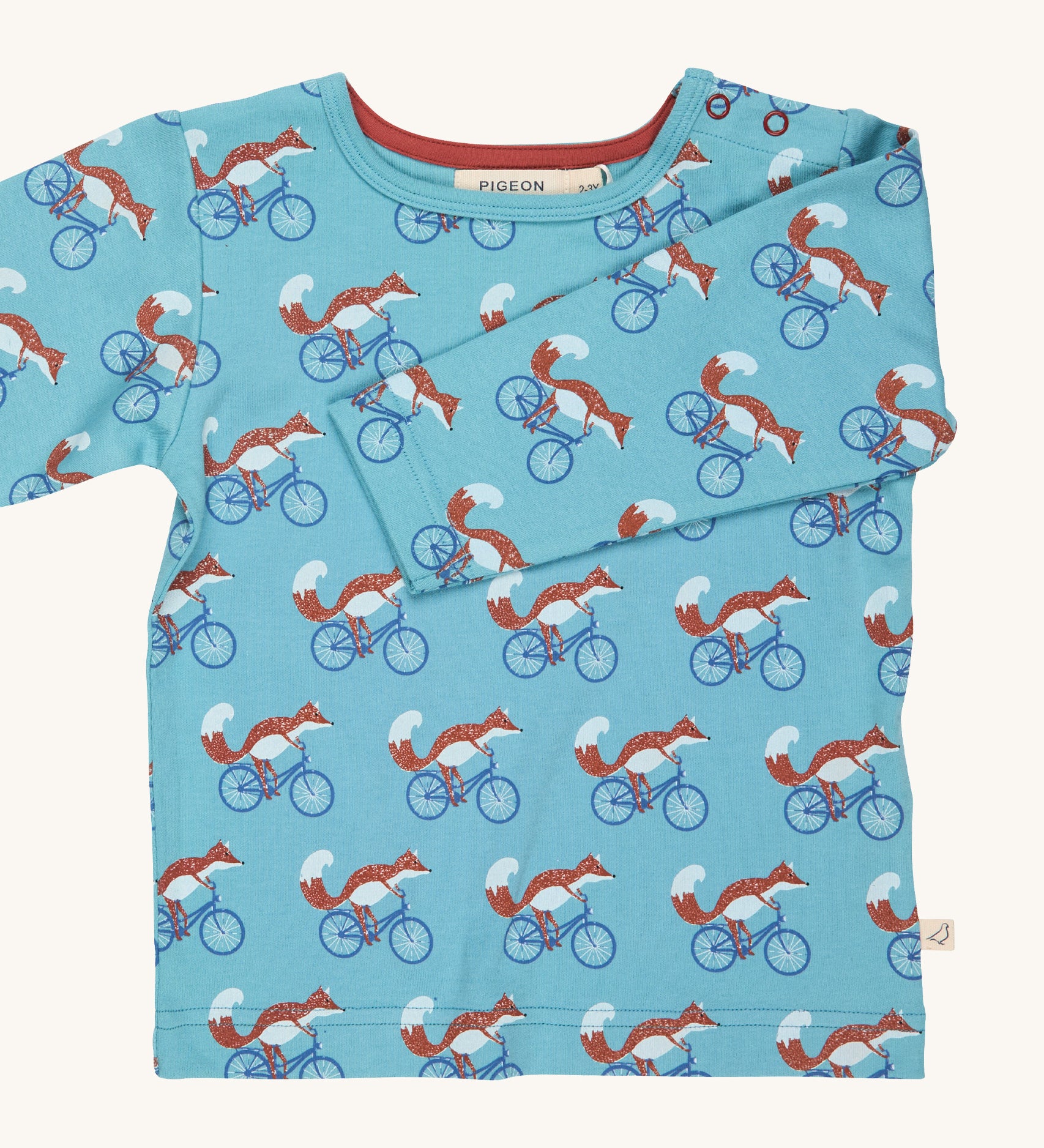 Pigeon Organics turquoise cycling fox t-shirt - GOTS organic cotton t-shirt with long sleeves. Features multiple prints of a fox riding a blue bike.