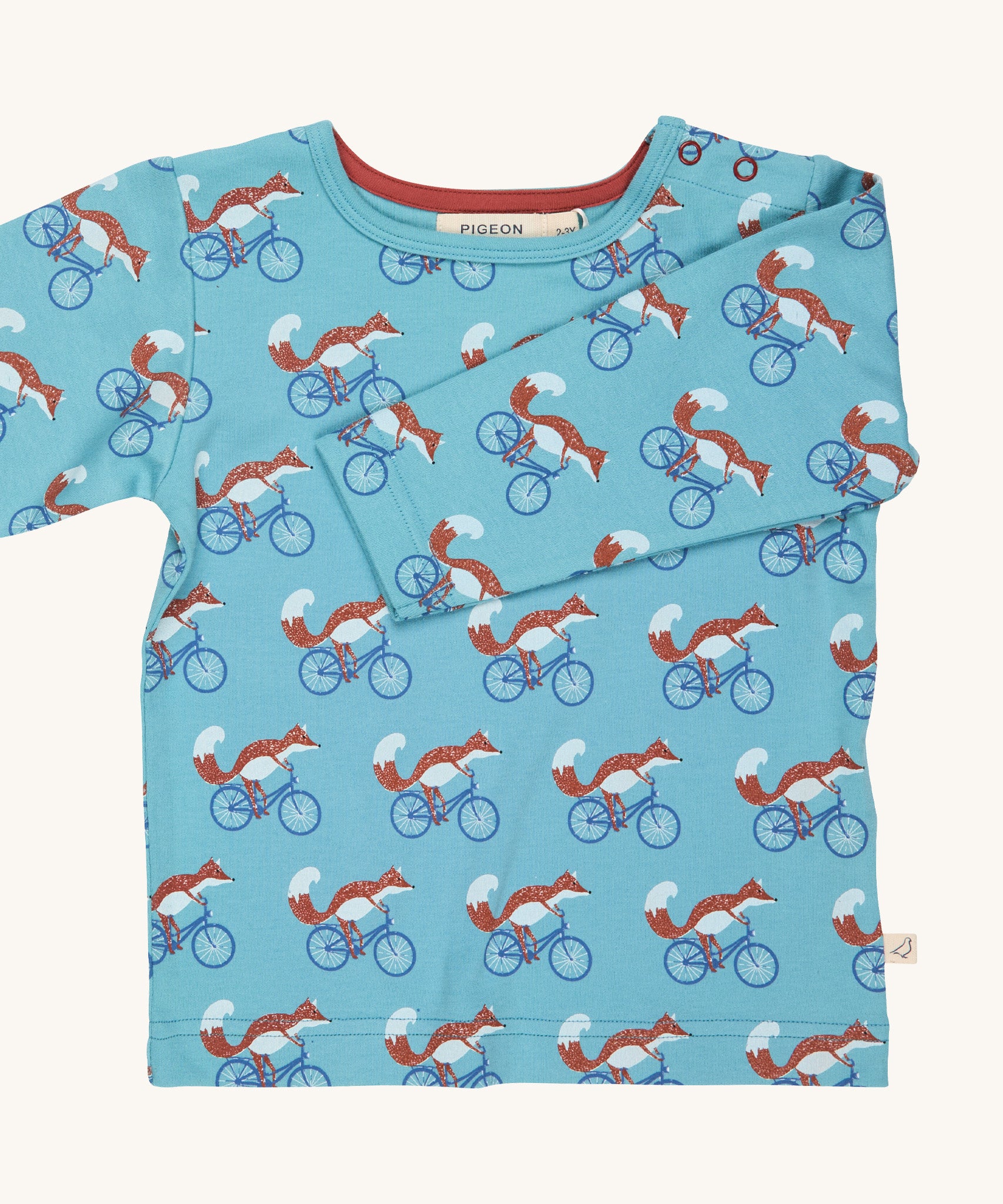 Pigeon Organics turquoise cycling fox t-shirt - GOTS organic cotton t-shirt with long sleeves. Features multiple prints of a fox riding a blue bike.