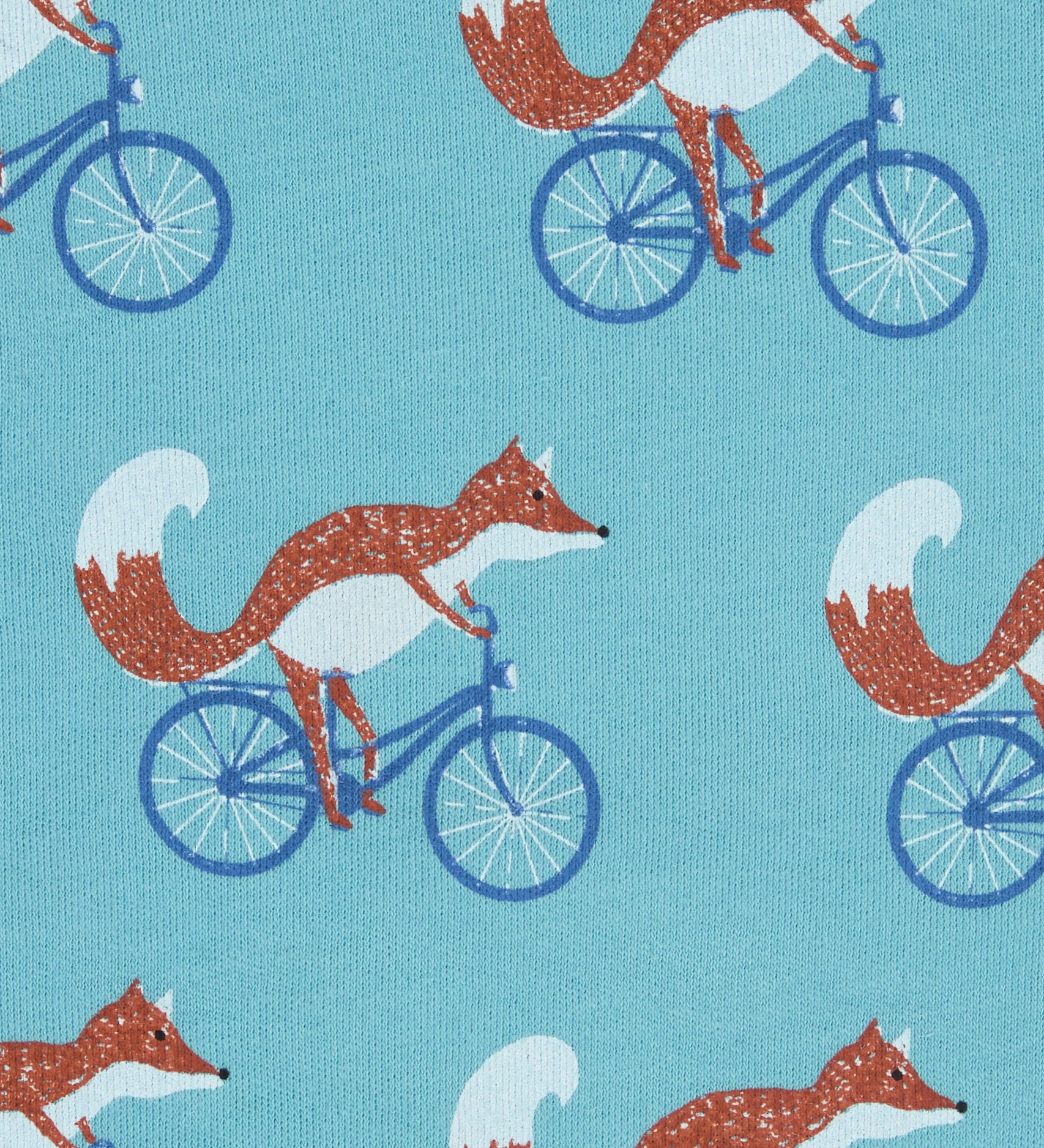 Close up of the Pigeon Organics cycling fox printed on organic turquoise cotton fabric.