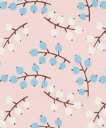 Close up of the Pigeon Organics winter berry design showing the multiple prints of light blue and white berries on light pink organic cotton fabric
