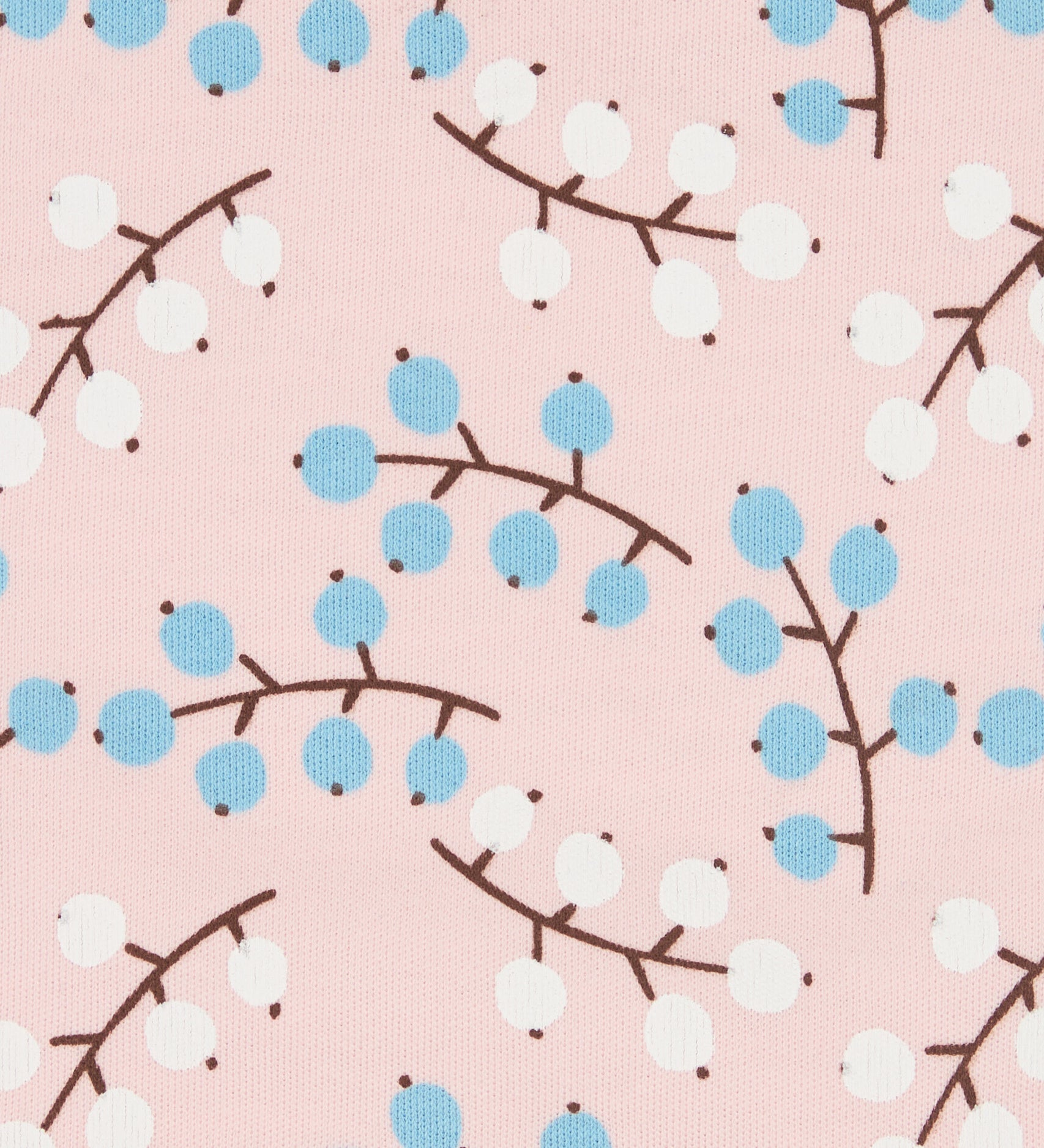 Close up of the Pigeon Organics winter berry design showing the multiple prints of light blue and white berries on light pink organic cotton fabric