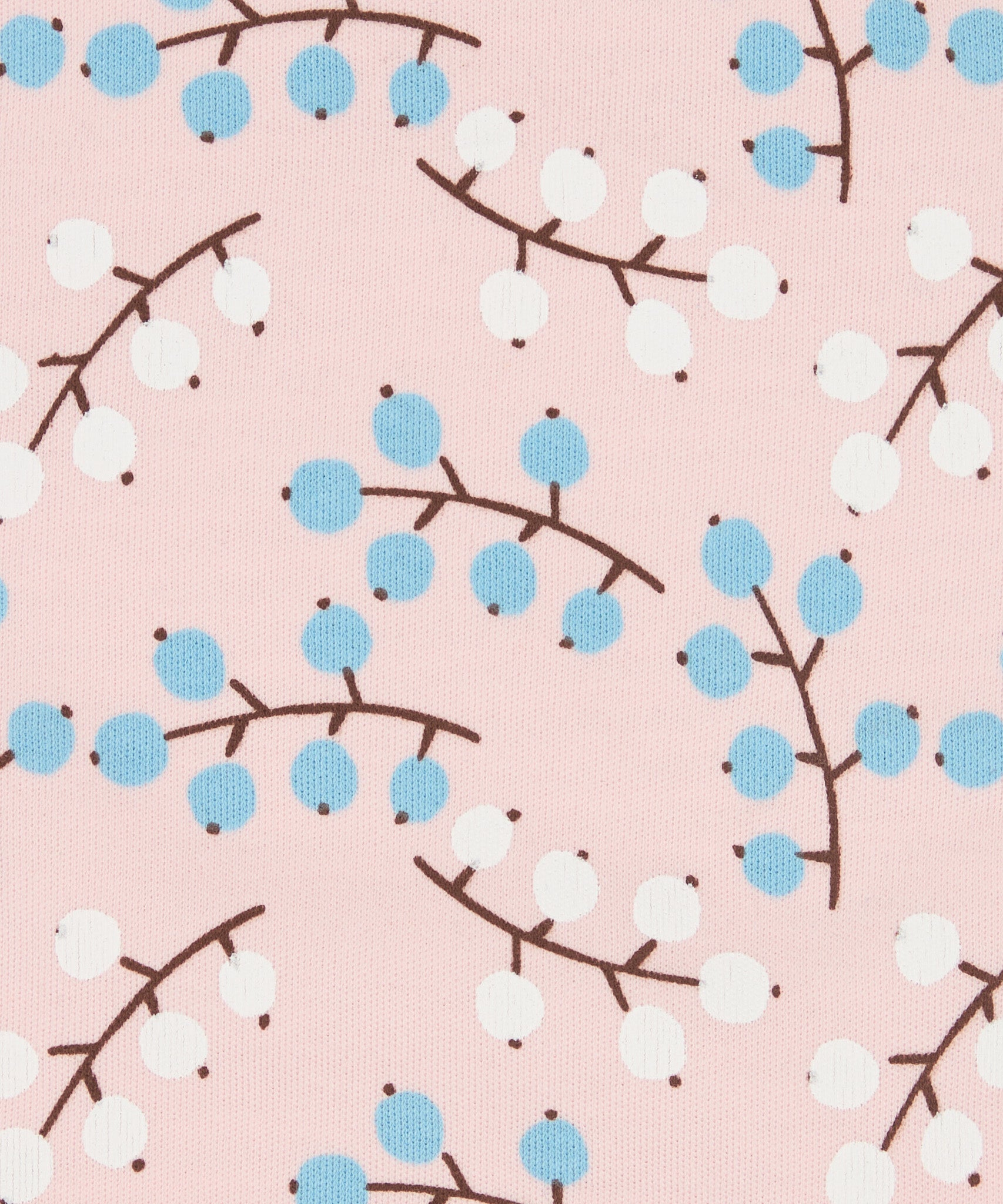 Close up of the Pigeon Organics winter berry design showing the multiple prints of light blue and white berries on light pink organic cotton fabric