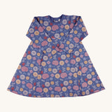 Pigeon Organics pinafore dress - GOTS organic cotton navy long sleeved dress with a popper fastener on the back for easy fitting. Features multiple prints of multicolour artistic flowers and leaves 