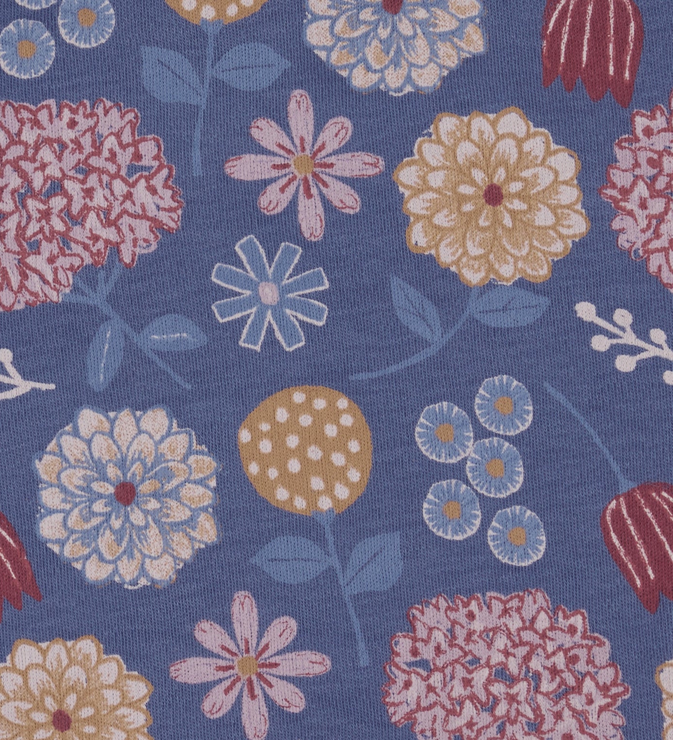 Close up of the Pigeon Organics winter bloom design showing the multiple artistic prints of flowers on light blue organic cotton fabric