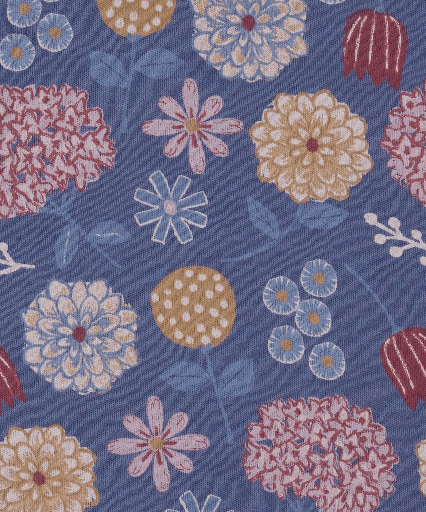 Close up of the Pigeon Organics winter bloom design showing the multiple artistic prints of flowers on light blue organic cotton fabric