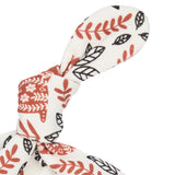 A close up of the Pigeon Organics orange squirrel knotted baby hat available at Babipur showing the knot detail