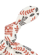A close up of the Pigeon Organics orange squirrel knotted baby hat available at Babipur showing the knot detail