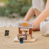 Child playing with the PlanToys bakery shop wooden toy playset.