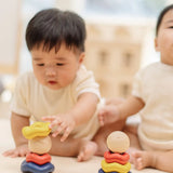 Baby playing with the PlanToys ball and wave stacker wooden baby stacking toy.