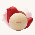 Plan Toys Bird Roller, a wooden rocking baby toy, shown with some shadows around it to show motion. 
