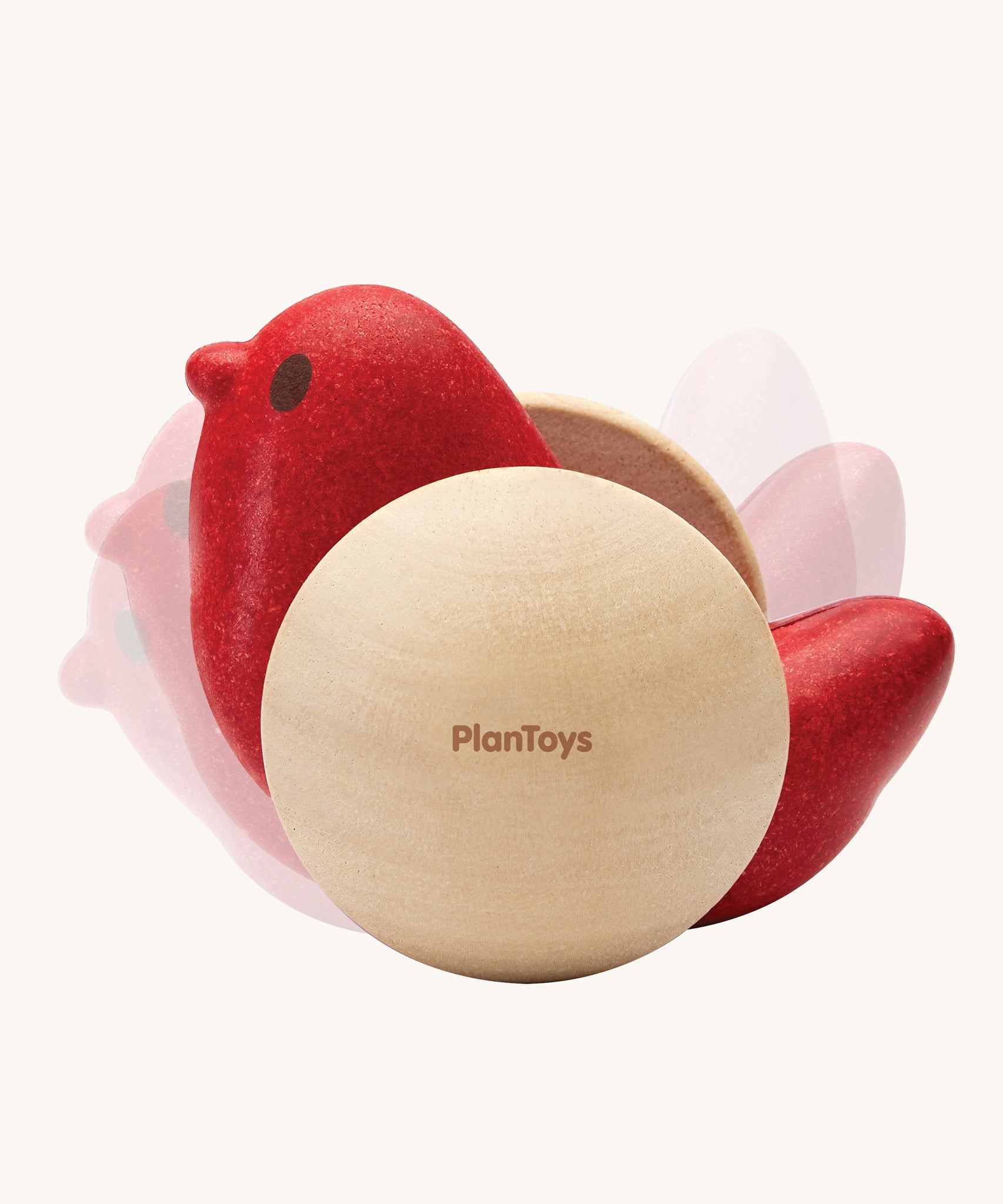 Plan Toys Bird Roller, a wooden rocking baby toy, shown with some shadows around it to show motion. 
