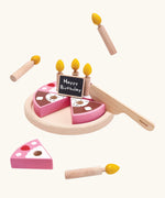 PlanToys wooden birthday cake set. Includes pink and brown slices, serving plate, candles and a chalkboard to write on