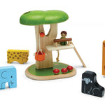 Plan Toys childrens stacking wooden animal jigsaw pieces laid out on a white background next to a plan toys tree house play set on a white background
