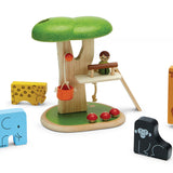 Plan Toys childrens stacking wooden animal jigsaw pieces laid out on a white background next to a plan toys tree house play set on a white background