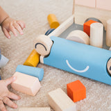 Close up of young childs hands putting toy blocks into the Plan Toys baby walker
