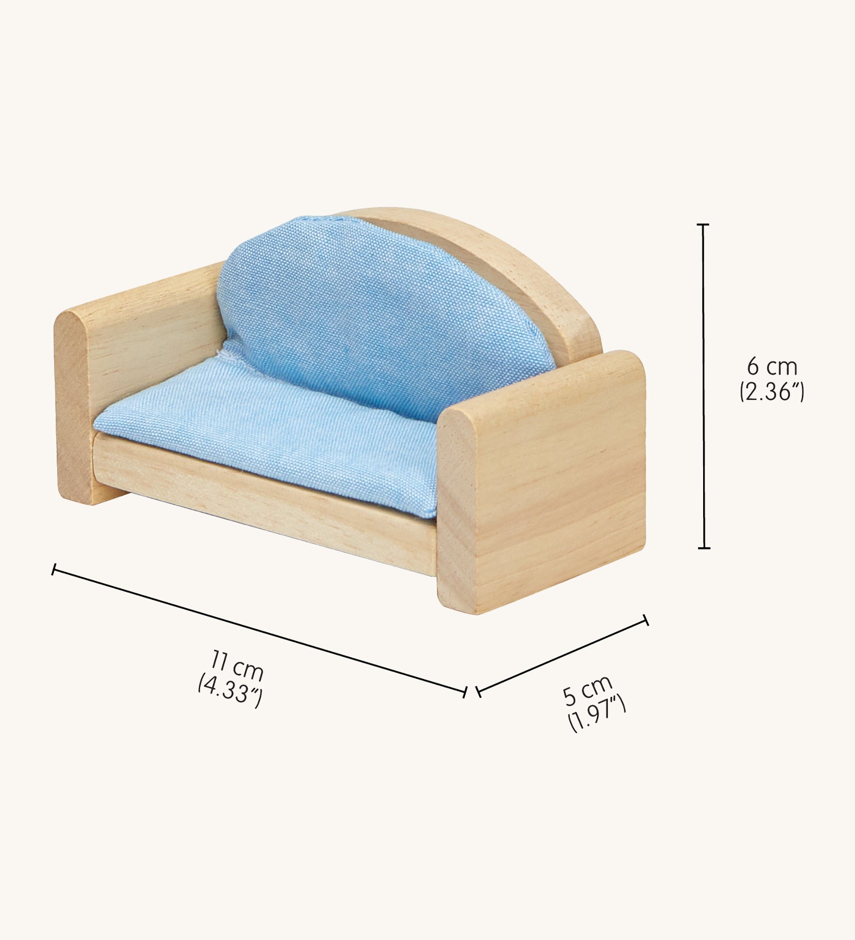 A close up of the sofa from the Plan Toys dolls house furniture set showing the dimensions and light blue cushion