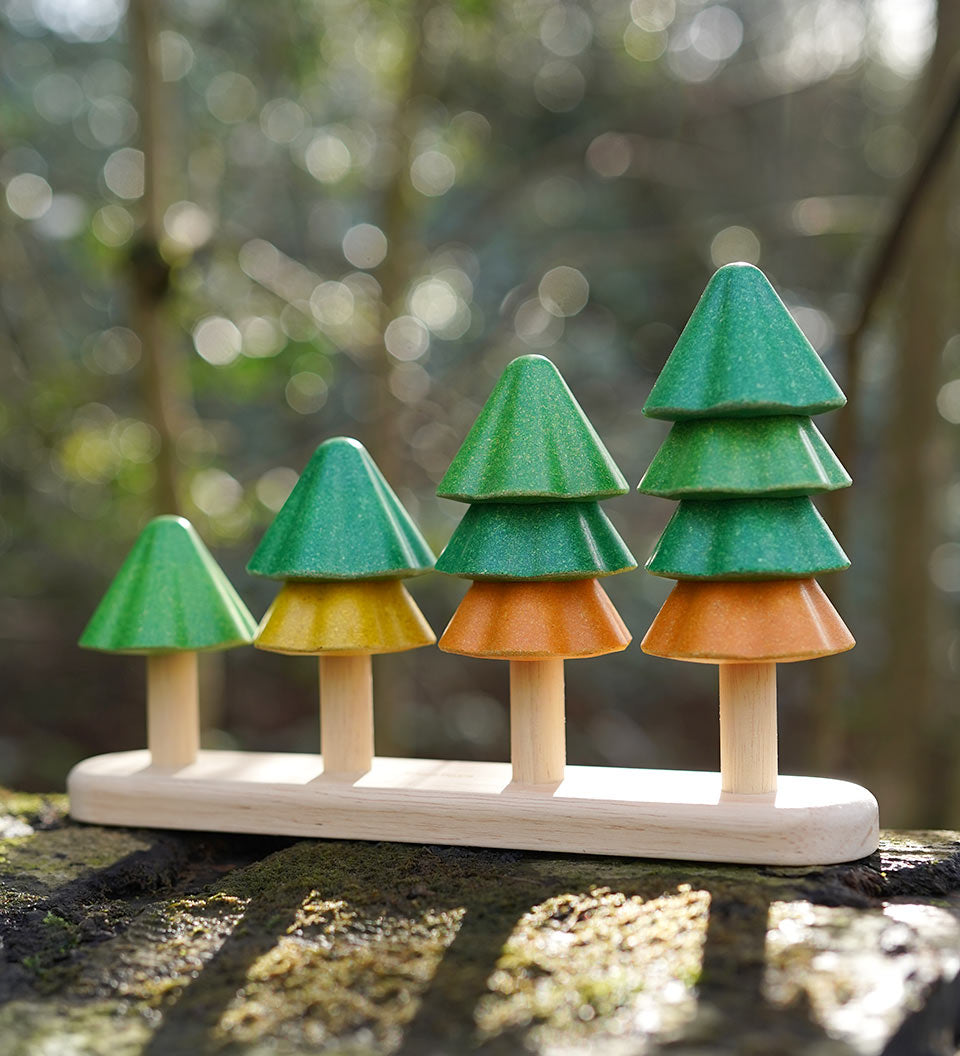 Close up of Plan Toys sustainable Sort and Count Tree toy on a wooden log