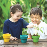 four colourful plant pots in green