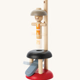 PlanToys Natural Rubberwood Jumping Acrobat Toy. The acrobat figure can be seen blurred in motion as it moves up. PlanToys have a vast range of sustainable wooden toys are available at Babipur.