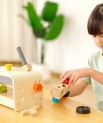 Child playing with the PlanToys little tool bench set.