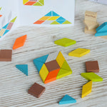 A square shape created using pieces from the PlanToys mini mosaic set, the ideas leaflet can be seen in the background. 