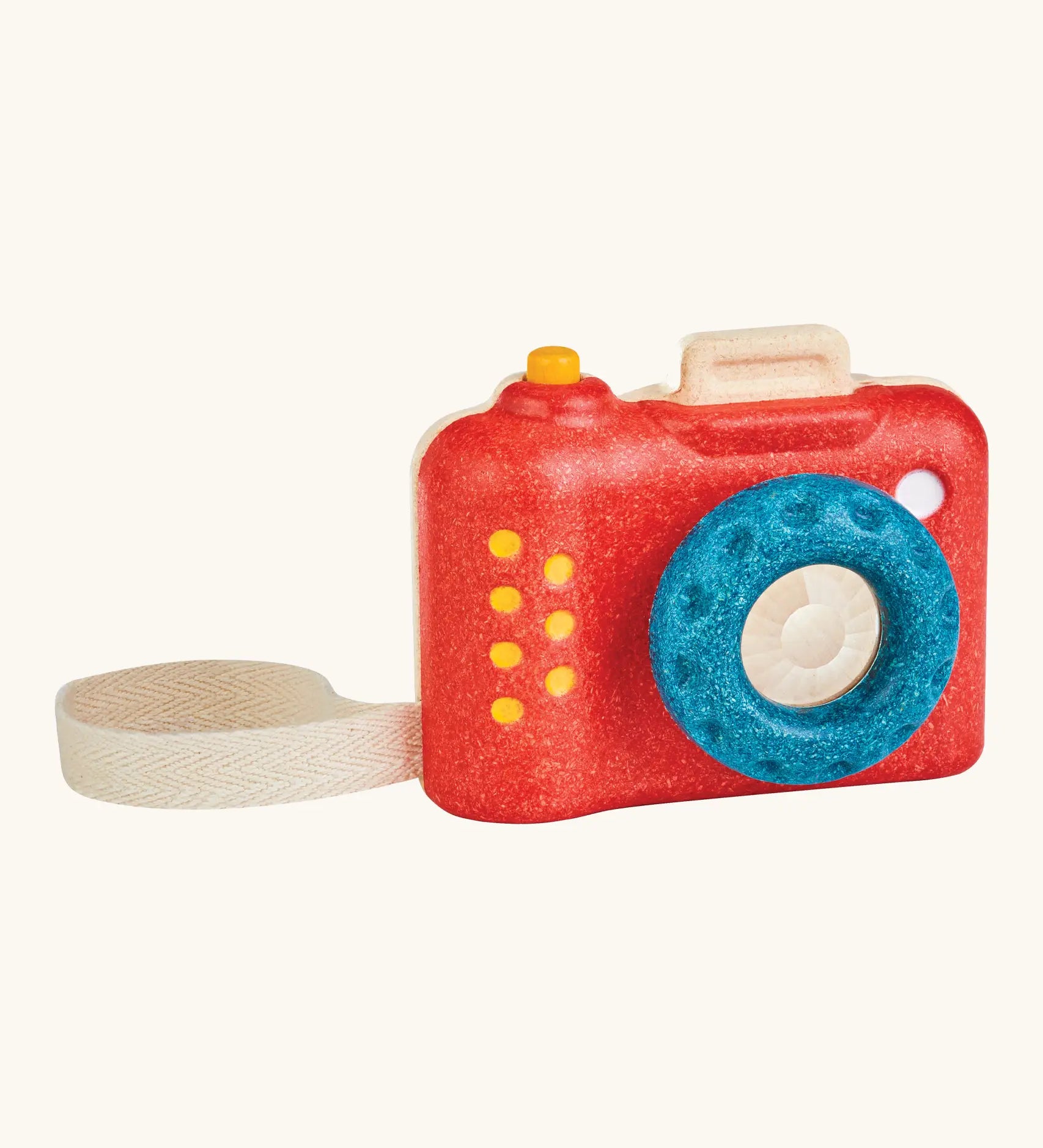 PlanToys my first wooden camera with a red body and blue lens. Features a working shutter button and cotton carry loop
