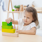A child playing with the Plan Toys Ordering Blocks. 