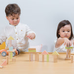 Two children playing with the PlanToys Pastel Blocks set. 